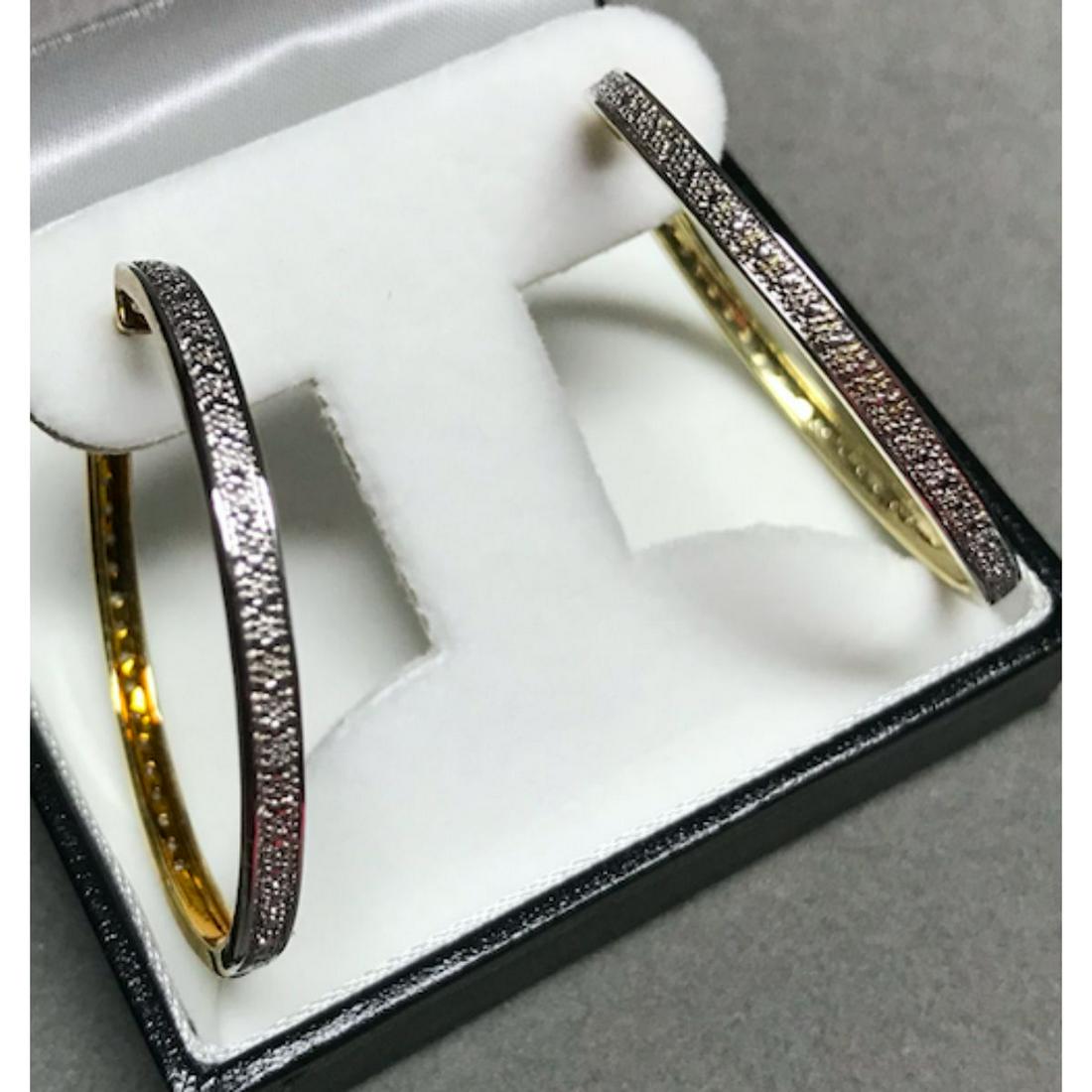 Diamond Gold Plated Hoop Earrings: Yellow gold plated hoop style earrings with diamond chips. 1 5/8" D each.