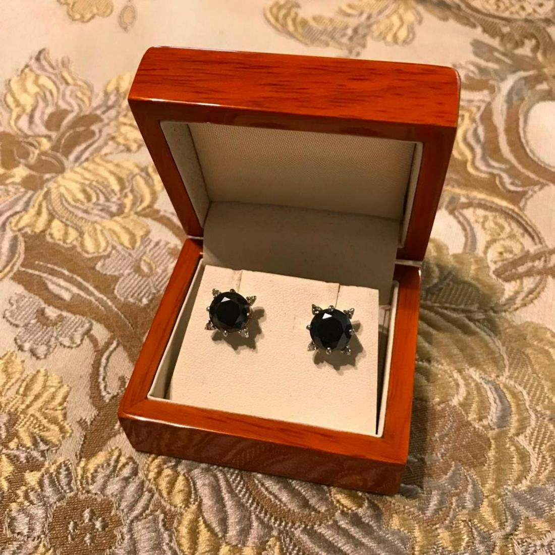 4.30ct Black Moissanite Diamond Sterling Earrings: 4.30ct Black opaque Moissanite diamond center stones, accented by tiny gray uncut Moissanite diamonds, set into sterling silver post earrings. 9654-030118-EB-76108