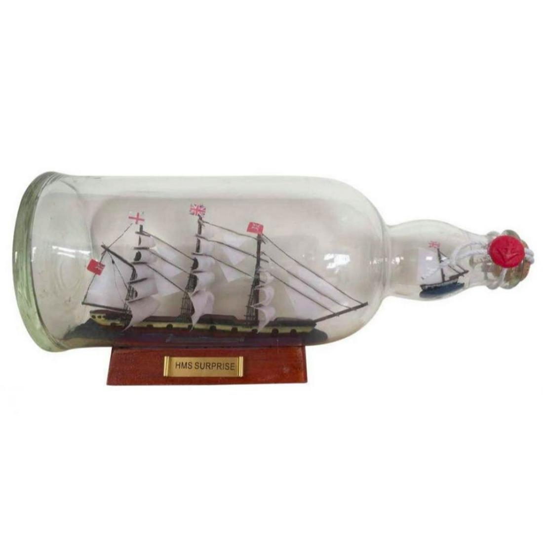 HMS Suprise, Master And Commander, Model Ship In Bottle: HMS Surprise from the movie Master & Commander, Model Ship In Glass Bottle. Fully assembled with handcrafted wooden hull & masts & all cloth sails mounted. Cork stopper and melted wax with an anchor i