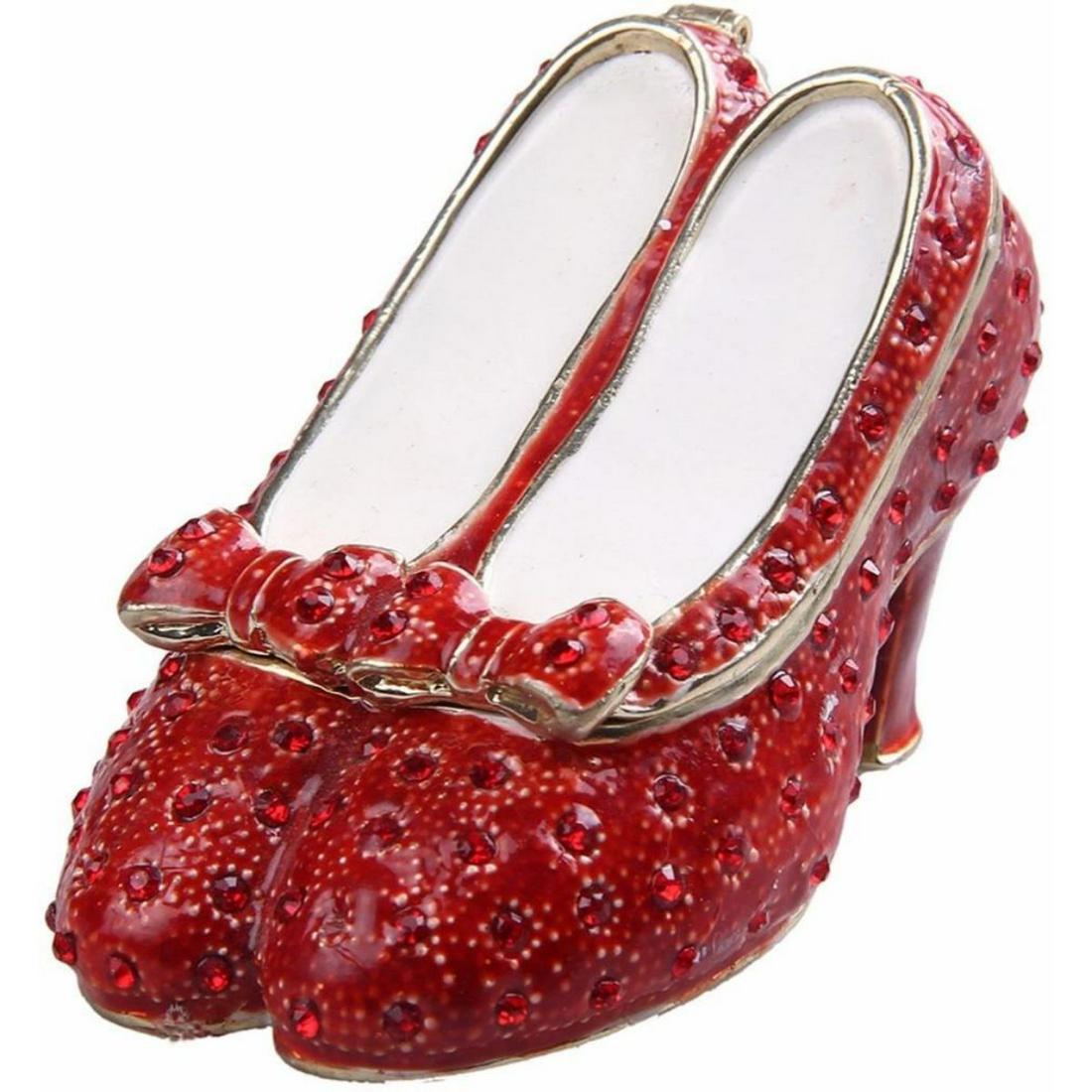 Ruby Slippers Wizard of Oz Trinket Jewel Box: Ruby Slippers from the movie The Wizard of Oz. Enamel & gilt over pewter, with embedded Austrian crystals. The top of the tiny shoes lifts up on a hinge, with magnetic closure, to reveal an enameled i