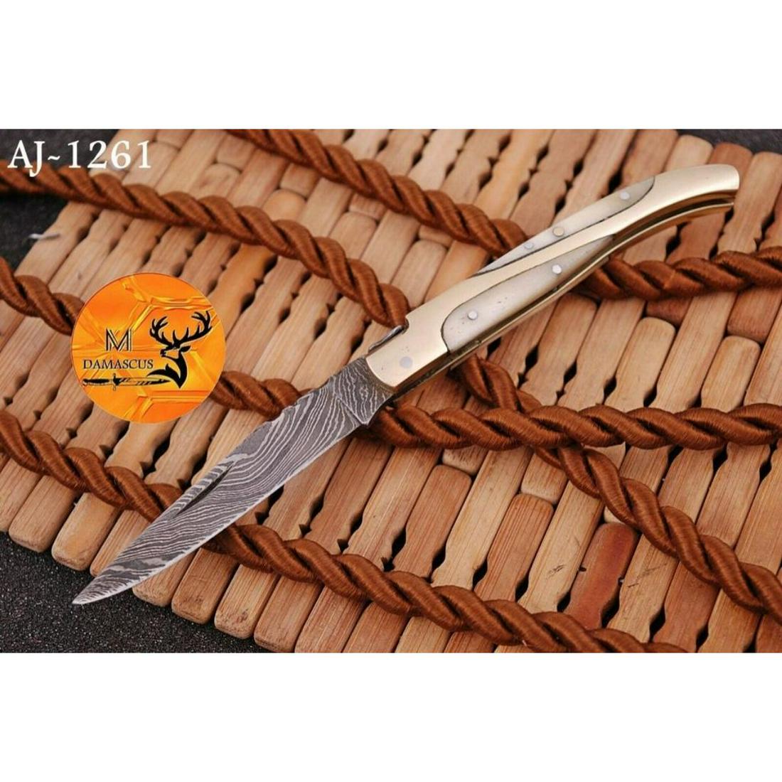 Custom Damascus Steel Camel Bone Folding Pocket Knife: Custom Damascus steel, camel bone & brass, folding pocket knife. Superb twist pattern design, hand forged with nice file work. Made of 512 layers of 4340 stainless steel and 1075 high carbon steel and