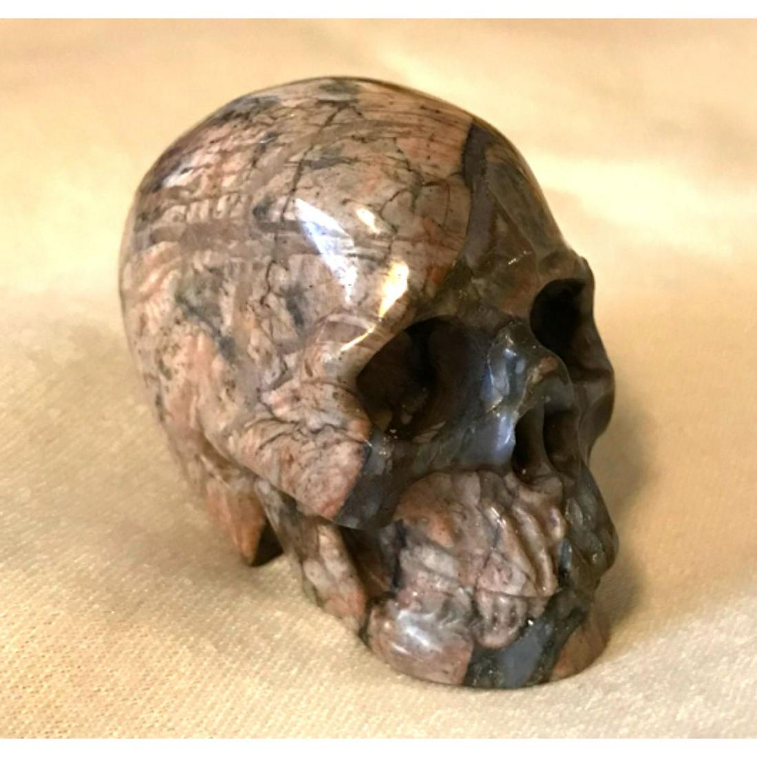 Carved Opal Gemstone Skull: Carved blue opal gemstone skull. ** has damage to jaw area on lower right side, per photos. Size: 2.0"x1.5"x1.2" (50x38x31mm) Weight: 2.8 OZ (81g)