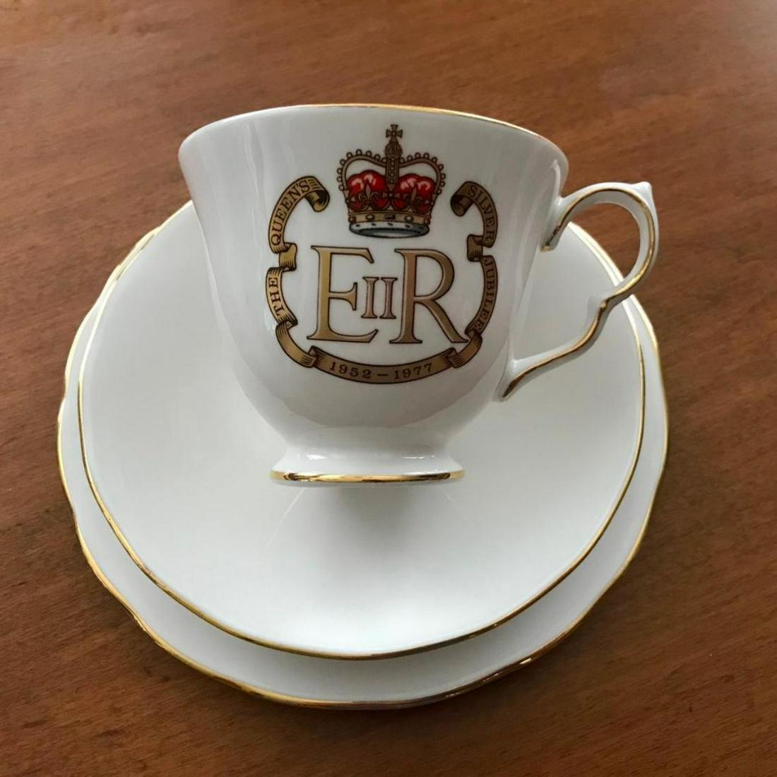 Queen Elizabeth Silver Jubilee China Tea Cup Set: Lovely bone china trio commemorating The Silver Jubilee of Queen Elizabeth II in 1977. Queen Anne bone china, made in England. Consists of English teacup, saucer and side / tea plate. Very collectable