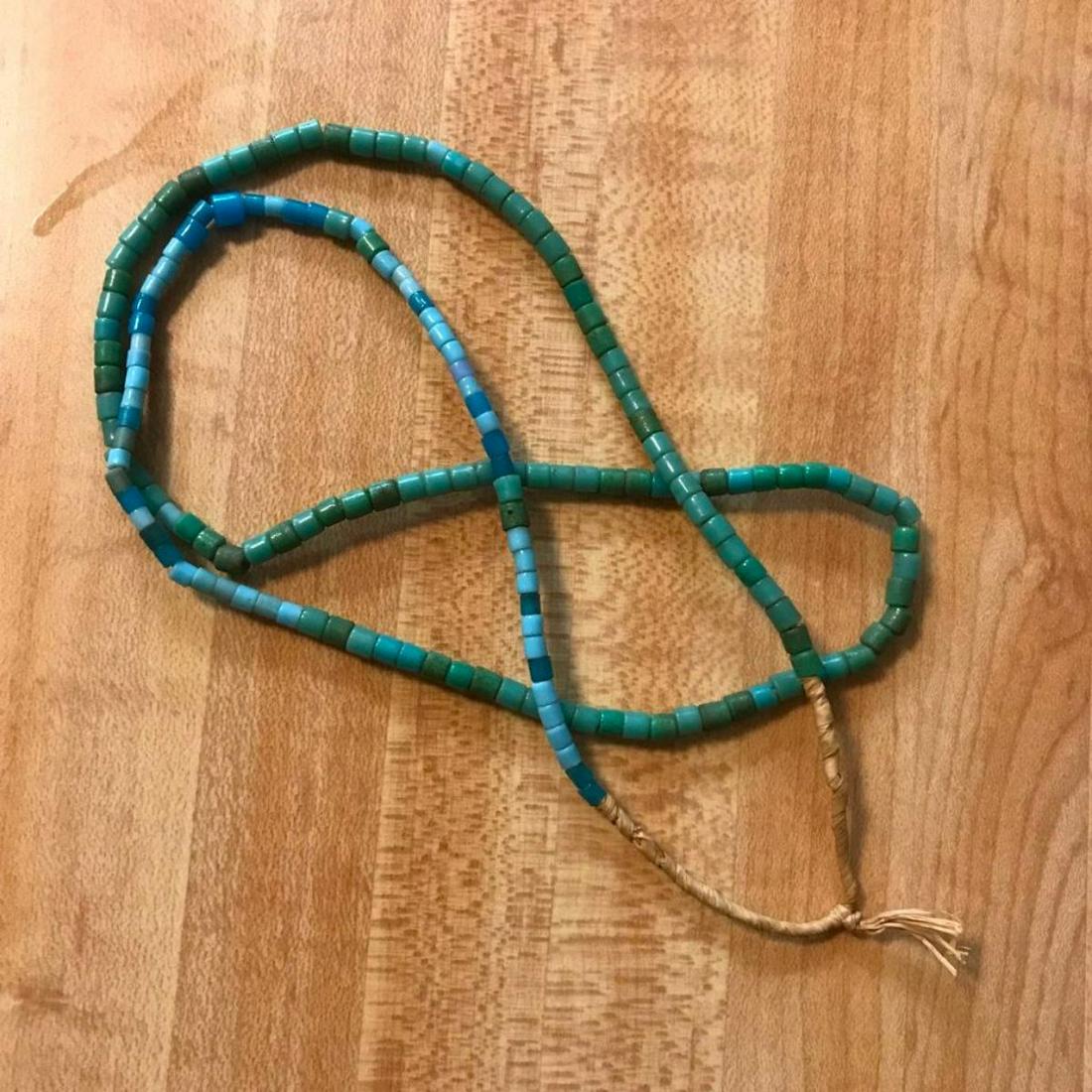 African Sand Cast Bead Necklace: Handcrafted strand of African sand-cast, turquoise blue beads 26" long necklace.