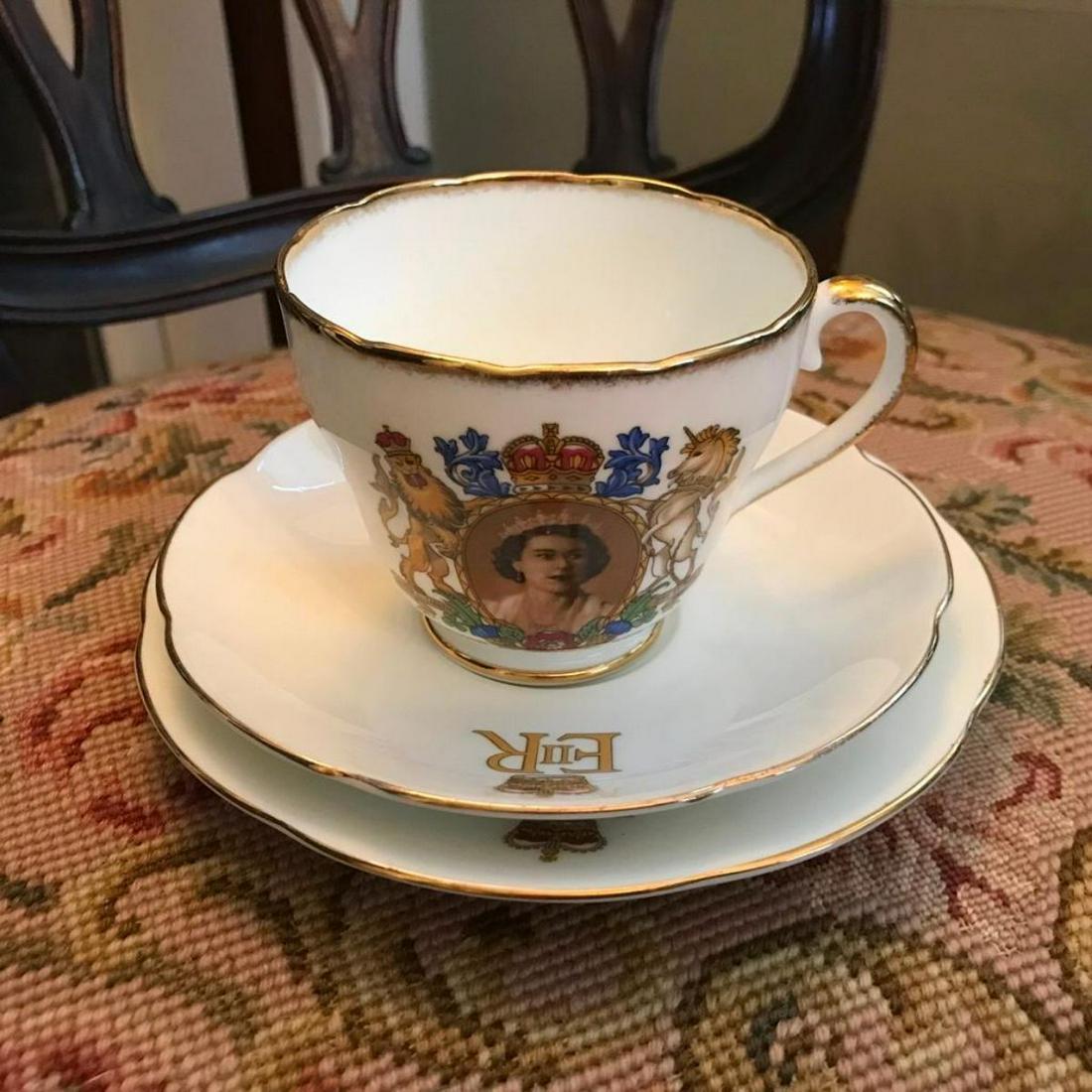 1953 Adderley Queen Elizabeth II Coronation Tea Cup Set: 1953 Commemorative Tea Cup, with matching Saucer & Plate set, by Adderley of England. Cameo portrait of Queen Elizabeth II & coronation dates appearing on all three pieces with insignia logo as well.