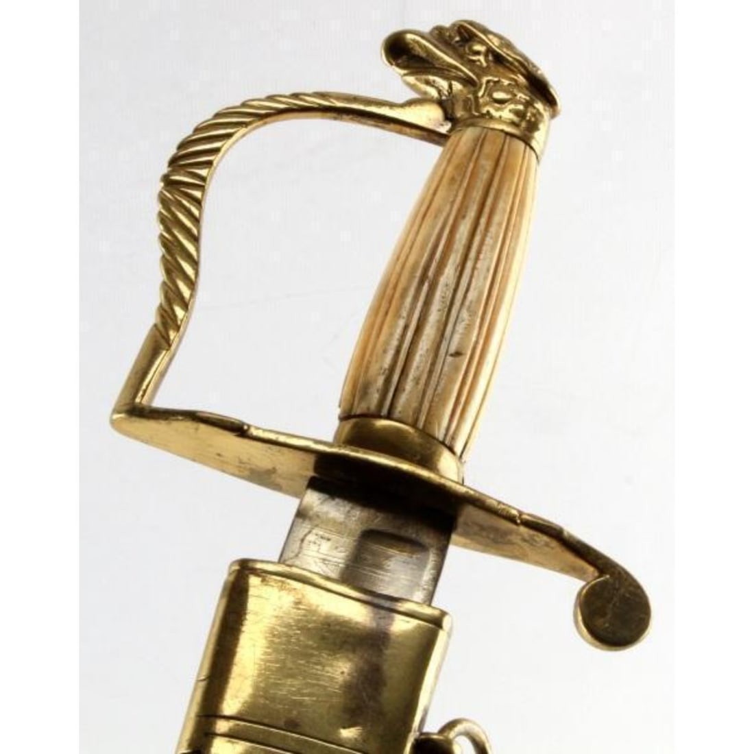 Rare Model 1812 U.S. Eagle Head Cavalry Sword: Beautiful vertically carved bone grip, etched "warranted" blade, bone grips with gilt brass guard, some play in grip and pommel, complete with its original leather scabbard with gilt-gold over brass f