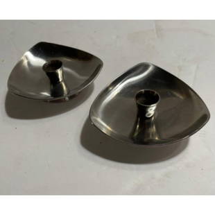 Mid Century Danish Staineless Steel Candlestick Holders: Mid Century Modern ( 1960 - 1969 ) Danish stainless steel candlestick holders by Arne Jacobsen, Denmark. Stamped on the bottom of each with the penguin symbol mark & 18/8.