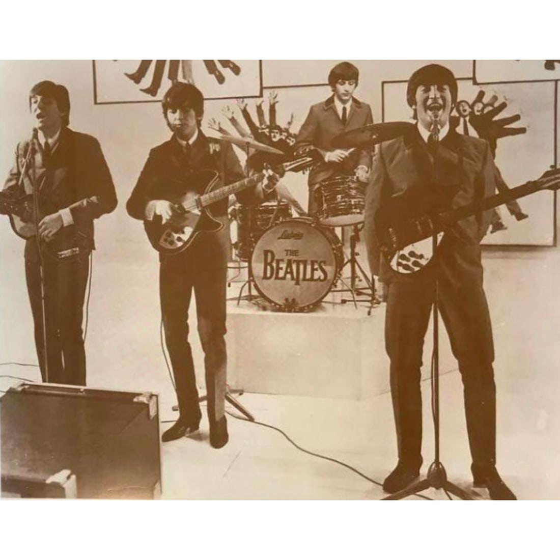 The Beatles Performing Photo Print: The Beatles Performing, 1960's. Sepia tone photo print, on card stock. Vintage printing from the early 1990's, in original packaging from The American Heritage Gallery. 11" X 14".