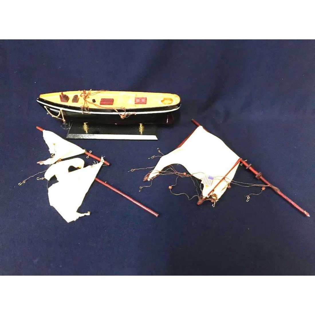 America Wooden Model Ship, Hobbyist, Repair: America Wooden Model Ship, for hobbyist, repair. Hand-crafted wooden model ship with hand stitched cloth sails, all rigging & brass hooks present, as well as flag & nameplate, attached to stand. Just