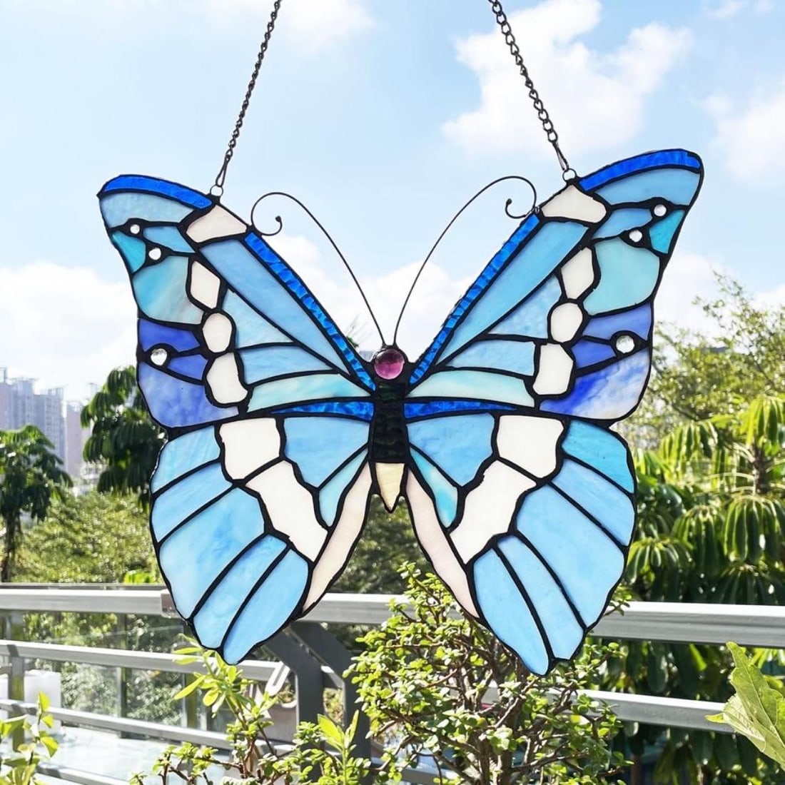 Stained Art Glass Butterfly Hanging Window Panel: Stained art glass hanging window panel in the form of a butterfly, created using 66 pieces of stained art glass & 7 glass beads wrapped in copper foil. 14' H X 12" W. Comes with hanging chain.