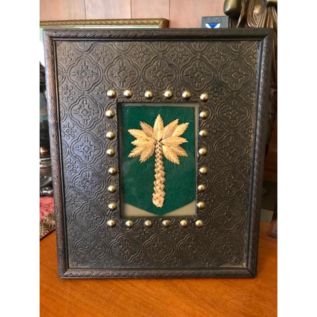 Handmade Palmetto Confederate Cockade: Handmade woven Civil War Confederate cockade, woven into the shape of a palmetto tree. Made by June Murray Wells from actual South Carolina palmetto fronds and sea oats. 3 3/8" L X 3" W displayed unde