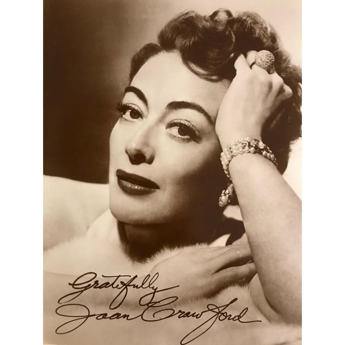 Movie Star Joan Crawford Photo Print: Sepia-tone photo print with printed signature ( not an actual signature ) on heavy card stock. Created in the early 1990s for The American Heritage Galleries. 11" X 14" with original packaging.
