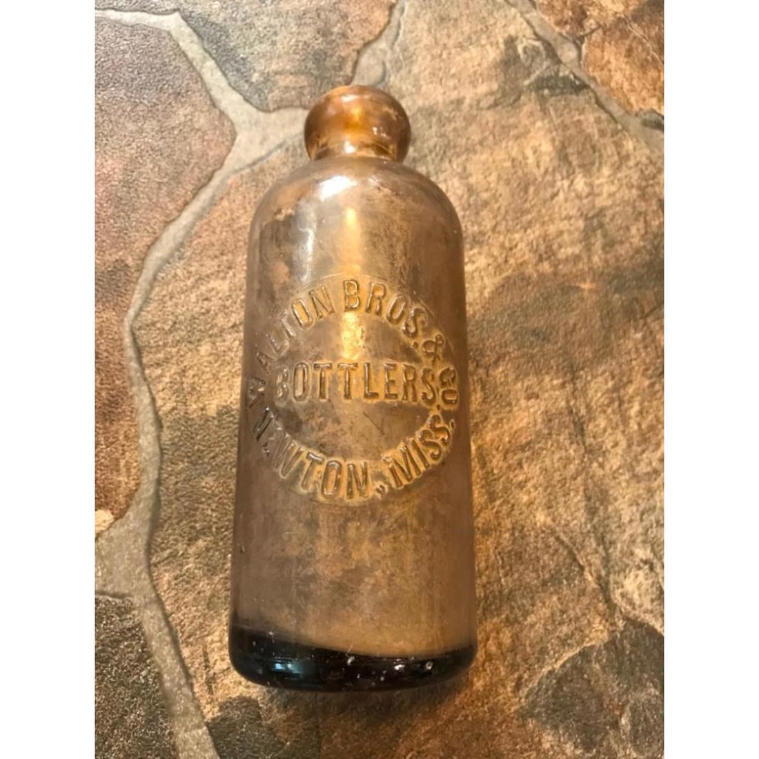Early 1900s Newton Mississippi Walton Bros Soda Bottle: Early 1900s Walton Brothers Bottling Co Newton, Mississippi Hutchinson soda bottle. 6 1/2" H. * dirt & part of the original metal cap still inside. a slight purple tinge to the glass