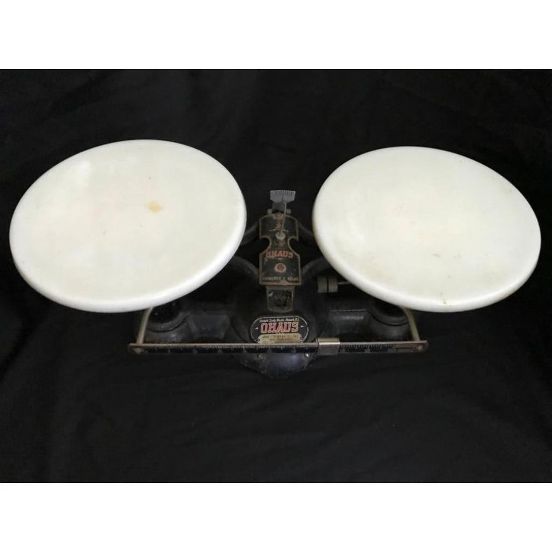 Antique OHAUS Iron Balance Scale: Antique OHAUS 2 kilo double beam balance scale with milk glass trays, made by the Newark Scale Works of Newark, NJ. In very good, usable condition with wear consistent with age. Measures about 14" x 6
