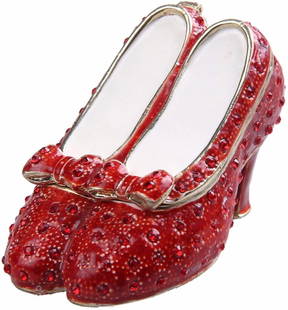 Ruby Slippers Wizard of Oz Trinket Jewel Box: Ruby Slippers from the movie The Wizard of Oz. Enamel & gilt over pewter, with embedded Austrian crystals. The top of the tiny shoes lifts up on a hinge, with magnetic closure, to reveal an enameled i