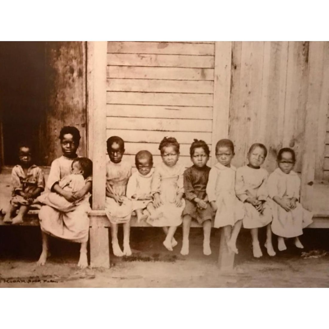 African American History, Little Children, Cabin Porch: African American History, Little Children on the porch of a cabin sepia-tone photo print. Created in the early 1990s for The American Heritage Galleries. Printed on card stock, with 11" X 14" mat boar