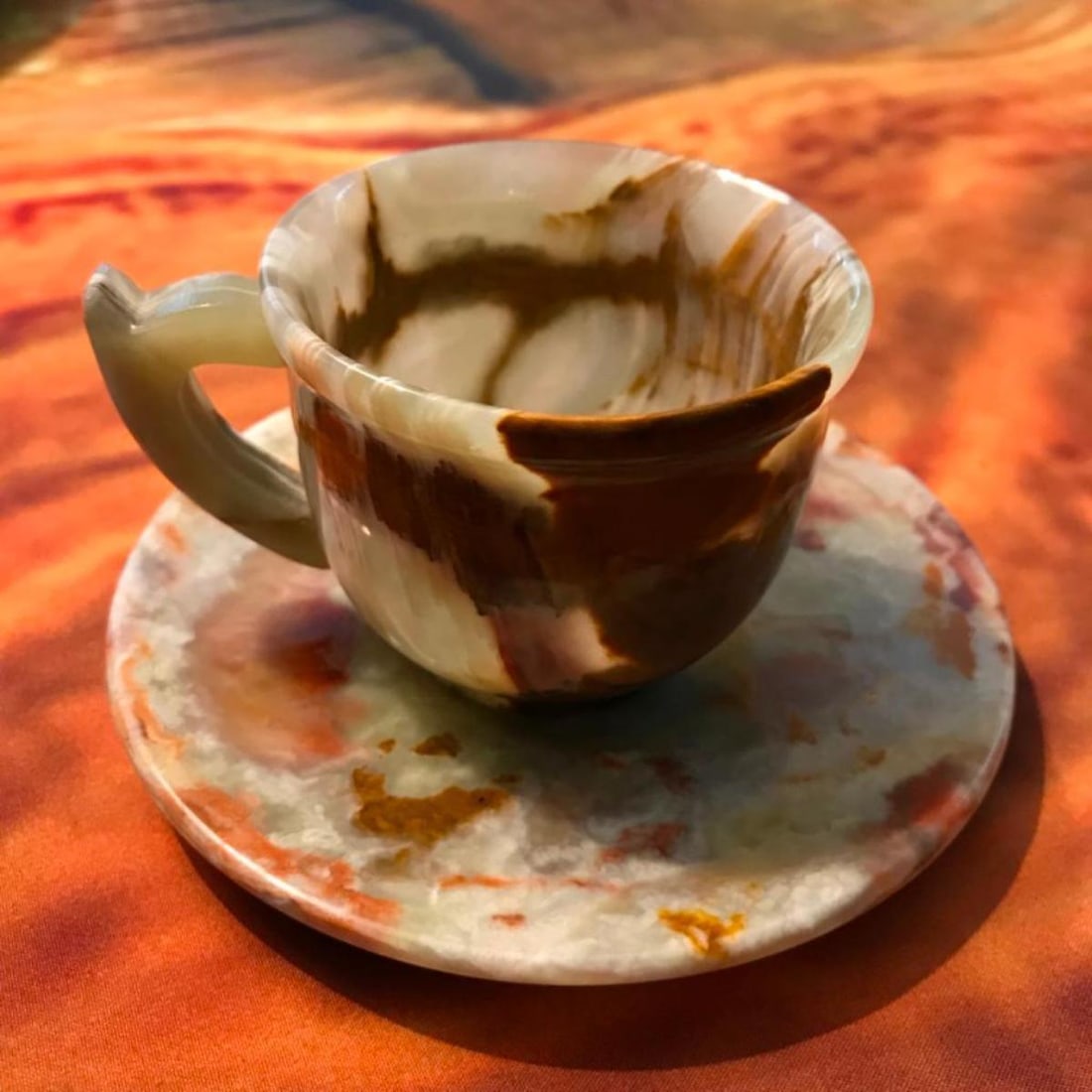 Carved Onyx Teacup Saucer Set: Hand made carved banded green onyx, calcite stone tea cup & saucer set. Cup - 4" X 3". Saucer - 5" D. 13oz weight.