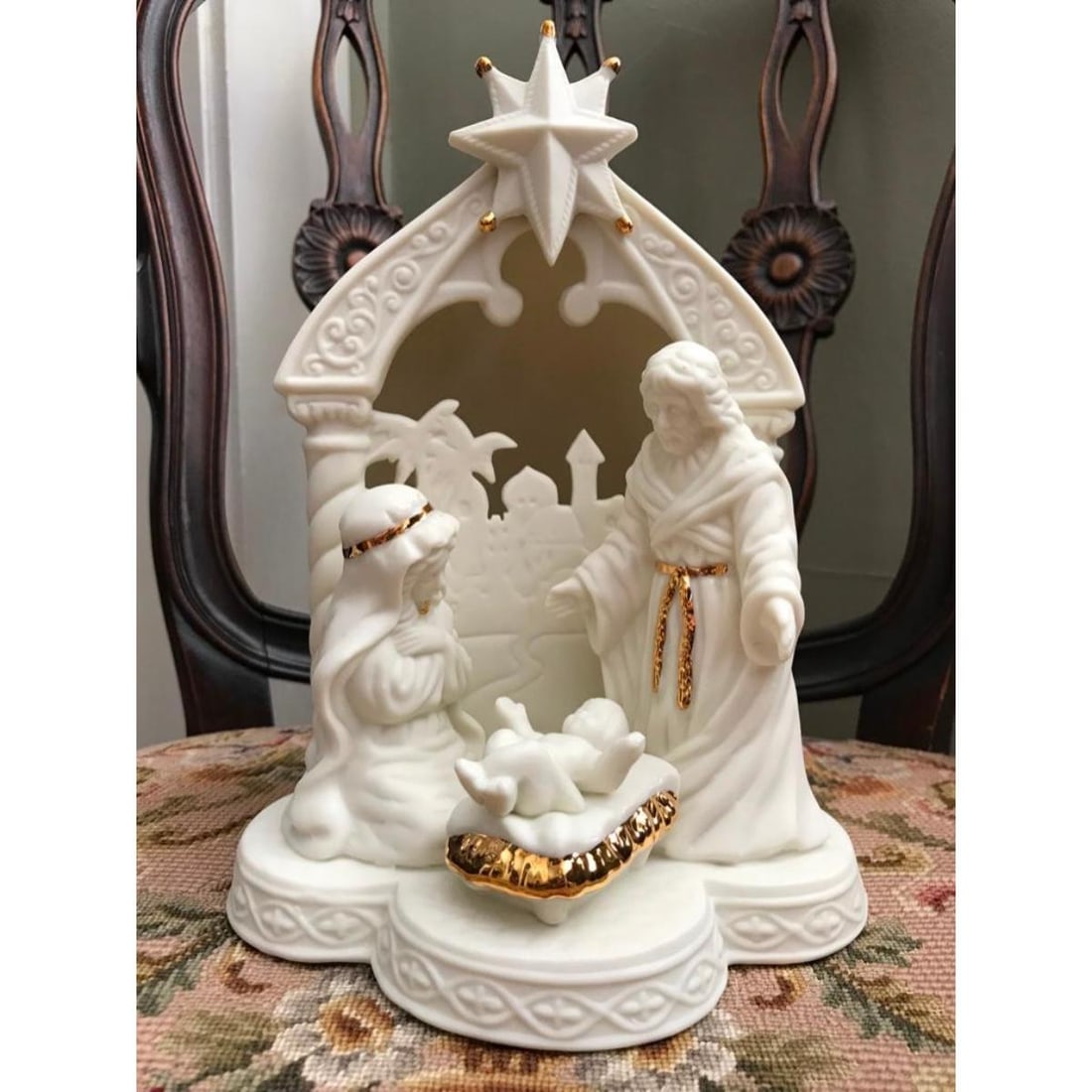 Bisque Porcelain Nativity Sculpture: Nativity sculpture created in bisque porcelain with gold lustre highlights. A light can be added to the inside through a hole in the back to light up the sculpture. 9" H X 6" W.