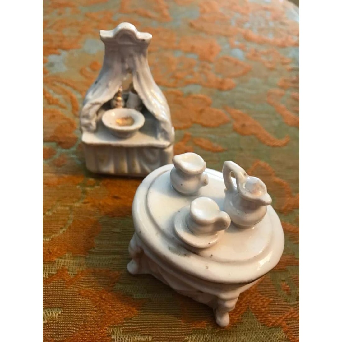 Pair of 19thc Victorian Porcelain Fairing Trinket Boxes: Pair of 19th Century porcelain trinket boxes, known as Fairing Boxes. One in the form of a tiny dresser, wash basin, the other in the form of a tea table with tea set. Both in good condition for age,