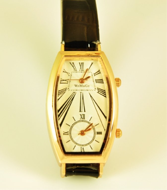 Unisex Wrist Watch: Unisex Wrist Watch With Alligator Like Skin Black Band. Watch Has 2 Times Zones. Case Is Gold Colored. Watch Has A Quartz Work.
