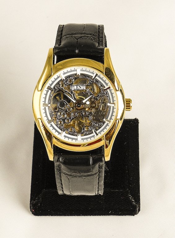 Men's Contemporary Skeleton Stainless Steel Watch: Men's Contemporary Skeleton Gold Colored Stainless Steel Watch. White Skeleton Face With White Dial Hands. Watch Has A Black Leather Band Accented With Golden Stainless Steel Case. Watch Has An Automa