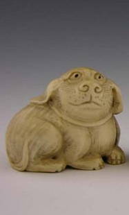 Carved Ivory Animal Netsuke a DOG signed: Carved Ivory Animal Netsuke, 20th c., of a DOG signed on the underside. Measures approx 2 inches tall