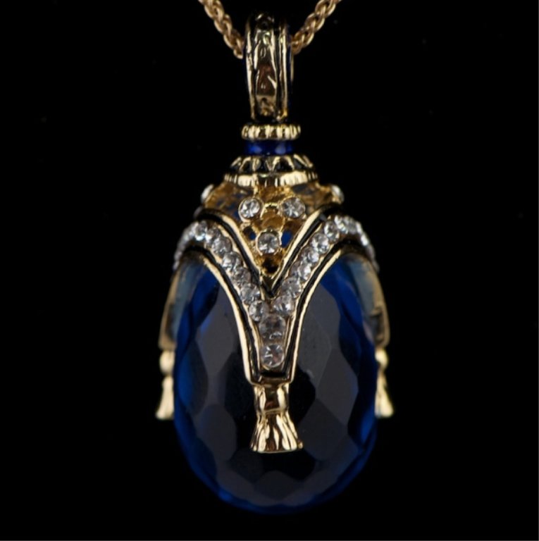 Sapphire Faberge Inspired Pendant: Faberge Inspired Pendant Elegant and grandiose, this Faberge inspired egg pendant is ready to add the extra something to complete the look of an outfit! Features: 1.25" (H) x 0.6" (D) 55 Austrian Crys