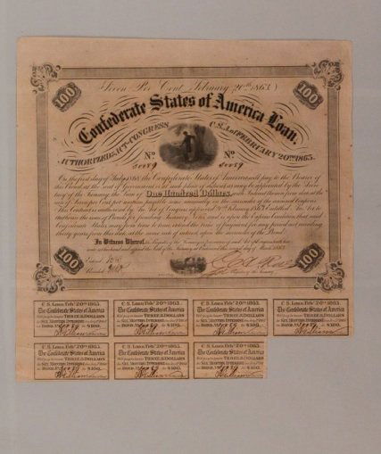 One hundred dollar seven % CSA loan certificate: One hundred dollar seven percent CSA loan certificate, issued Richmond, 1863, no. 30089. Total of 7 $3 coupons attached. Condition: scattered foxing, light creasing at corners, a few scattered tiny pi