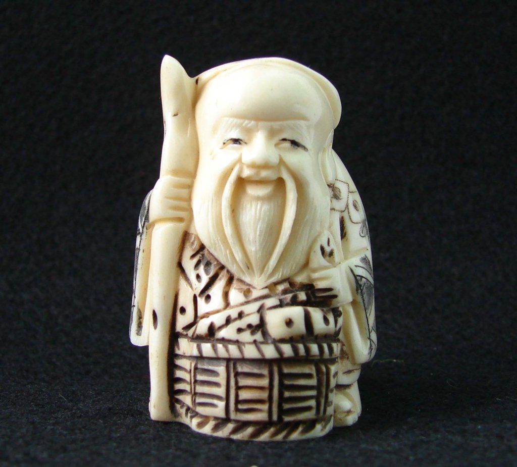 Hand Carved Ivory Netsuke Figure: Hand Carved Ivory Netsuke Figure measures approx 2 inches tall