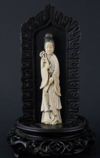 Ivory Carving of Guan Yin on handcarved wood stand: Ivory Carving of Guan Yin on a beautifully carved wood stand. Measures 8 1/4in Tall x 5in Wide.