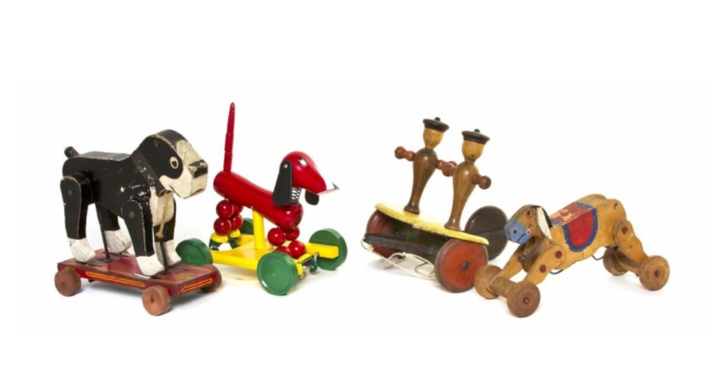 A Collection of Three Wood Pull Toys, comprising a: A Collection of Three Wood Pull Toys, comprising a Swedish Brio dachshund, an American Frantz Boston Terrier, and another example of two dancing figures, together with a Japanese bucking donkey. Lengt