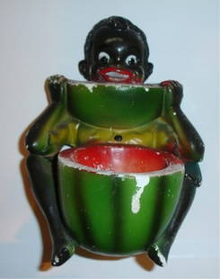 Black America vintage chalkware sculpture showing: Black America vintage chalk ware sculpture showing a boy eating a watermelon. It measures 6 inches high and 3 inches deep. The watermelon is hollow and forms a very small bowl. The back is flat and