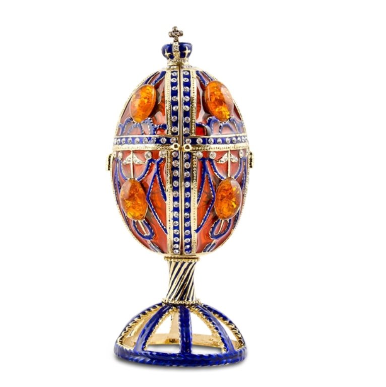 Faberge Inspired Amber Egg: Beautiful amber colored egg with blue enamel rays. The egg is ornamented with 8 amber gems located on each plate. Tiny crystals surround the blue enamel that divides the egg into 8 similar sections. A