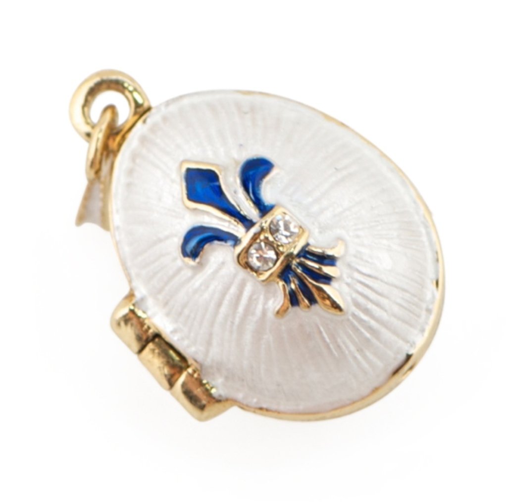 Fleur-de-lis Faberge Inspired Locket: The Faberge pendant contains the same symbol as the blue ornamentations but in a a golden texture with small crystals. This piece offers simple contrasts of color and texture. Elegant and grandiose, t