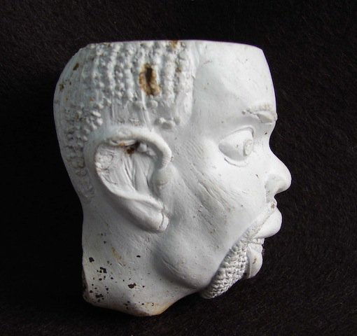 Early Clay Pipe depicting the head Southern Slave: Early Clay Pipe depicting the head of Southern Slave during the 1840 to 1860 period. This pipe was unearthed at a tavern site in South Carolina and were most probably cast in the south and given to bi