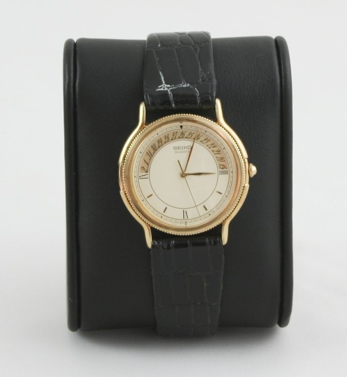 Women's Seiko Leather Band Watch: Women's Seiko, Stainless Steel Case, White Quartz Face with Moon Cycle ( Time, Day & Date ) & Cherry-Brown Leather Band. Name engraved on back. Needs new battery. Sold as is.