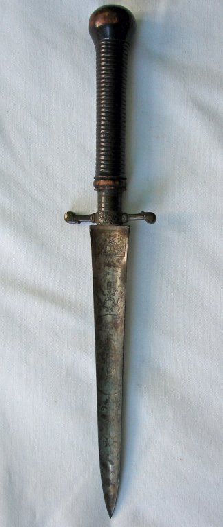 Early 17th Century Continental Armor Piercing Dirk: Early 17th century, Continental armor piercing triangular dirk, with fine engraving and fabulous grip. Blade measures 8.5". Overall length - 14.5". Engraving includes early Masonic Emblems, cherubs, a
