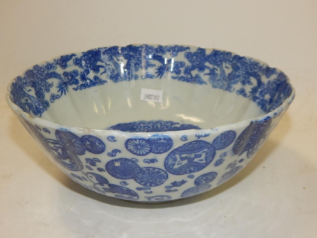 CHINESE BLUE AND WHITE BOWL: 3 AND 1/2" TALL, WITH A 8 AND 1/4" DIAMETER. MINOR PAINT LOSS, HAIRLINE CRACK DOWN SIDE, CHIPS ALONG INSIDE RIM