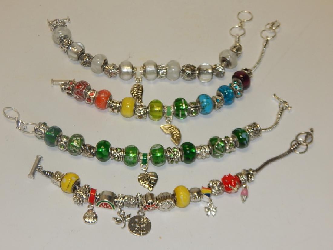 FOUR COSTUME CHARM BRACELETS (1 of 2)