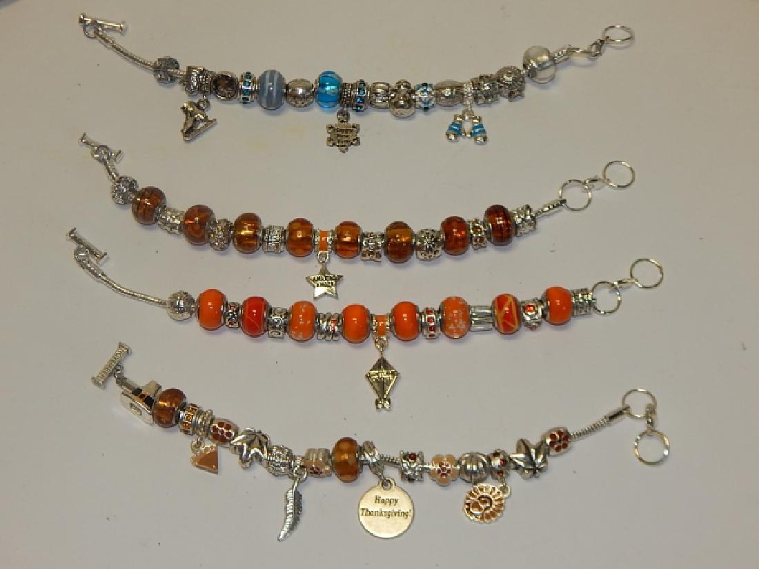 FOUR COSTUME CHARM BRACELETS (1 of 2)