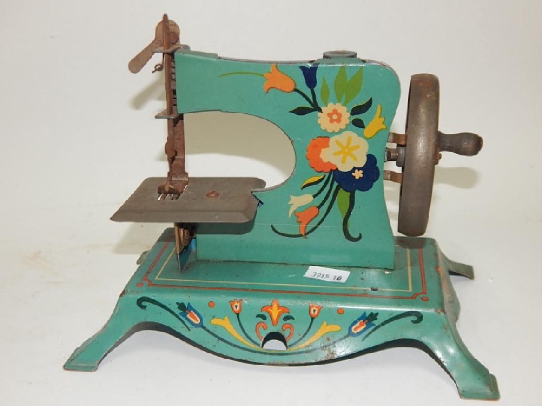 CHILD SEWING MACHINE: 6 AND 1/2" TALL, 8 AND 1/4" LONG, 5" WIDE