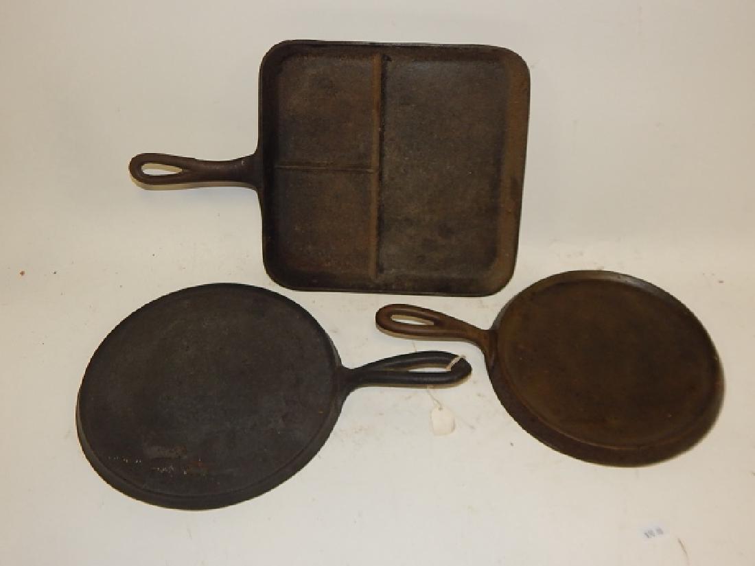 THREE CAST IRON PANS: COMBINED WEIGHT 8LB, 5.4OZ. ONE SIGNED WAGNER, ONE SIGNED SIDNEY, SQUARE DIVIDED PAN IS UNSIGNED.