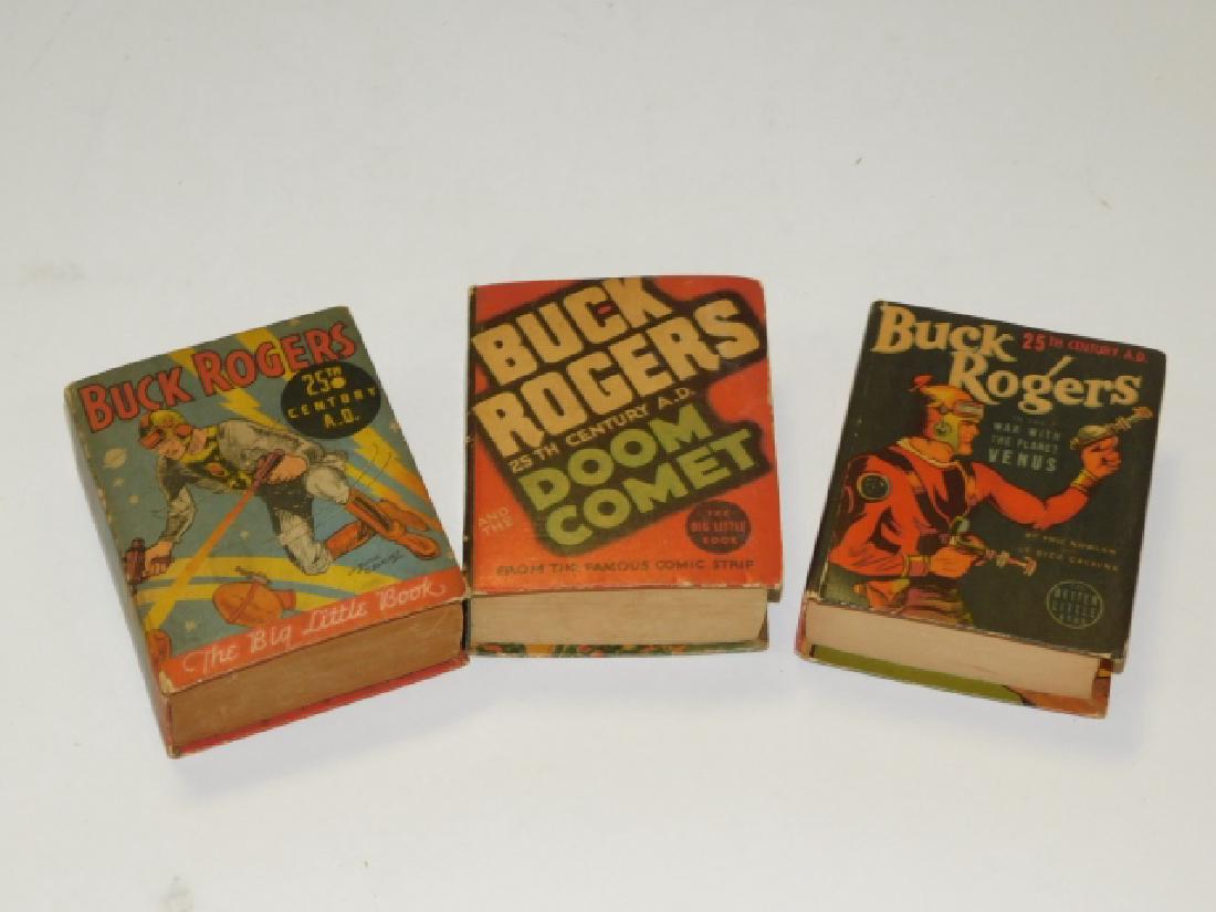 THREE BUCK ROGERS BIG LITTLE BOOKS: POCKET SIZE- ROUGHLY 4 1/2" BY 3 3/4". WRITING ON INSIDE COVER/PAGES, OUTSIDES HAS WORN EDGES.