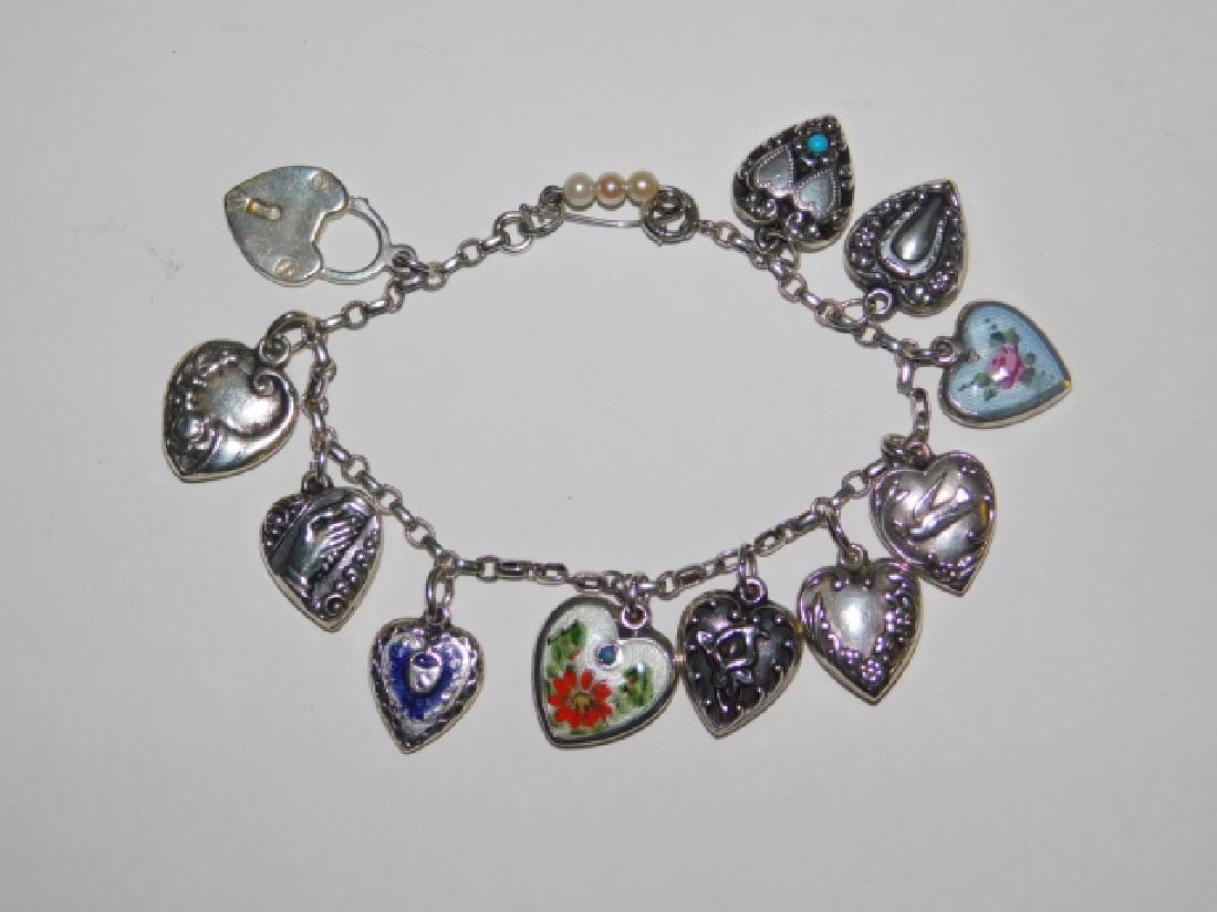 STERLING SILVER CHARM BRACELET: 1.0OZ. DARLING HEART SHAPED CHARMS. 7" LONG