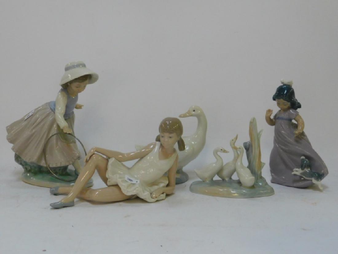 COLLECTION OF FIVE NAO FIGURINES: TALLEST IS 7 3/4". SMALLEST IS 4 3/4"