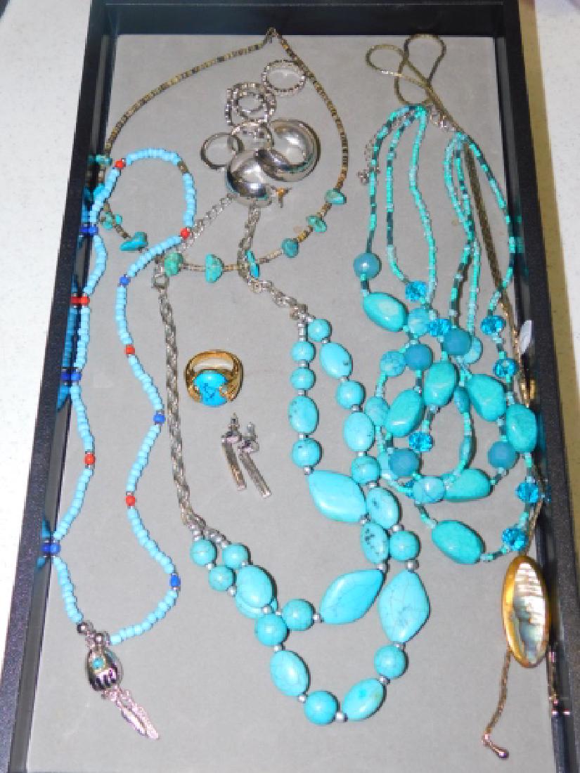 COLLECTION OF COSTUME JEWELRY: VIBRANT NECKLACES AND RINGS. ALONG WITH CLASSIC PIERCED EARRINGS