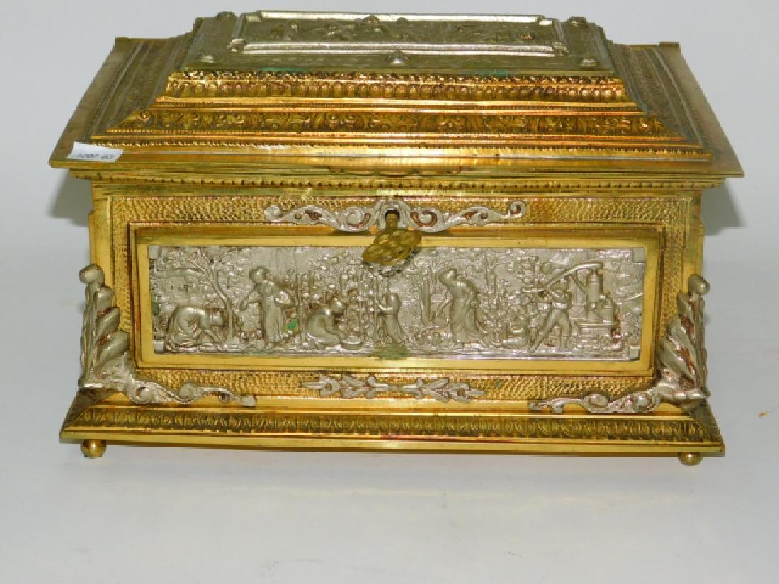 BRASS DRESSER CASKET: WITH KEY. MARKED MADE IN SPAIN ON BOTTOM. 11 AND 1/2" LONG, 7" TALL, 8 AND 1/2" DEEP.