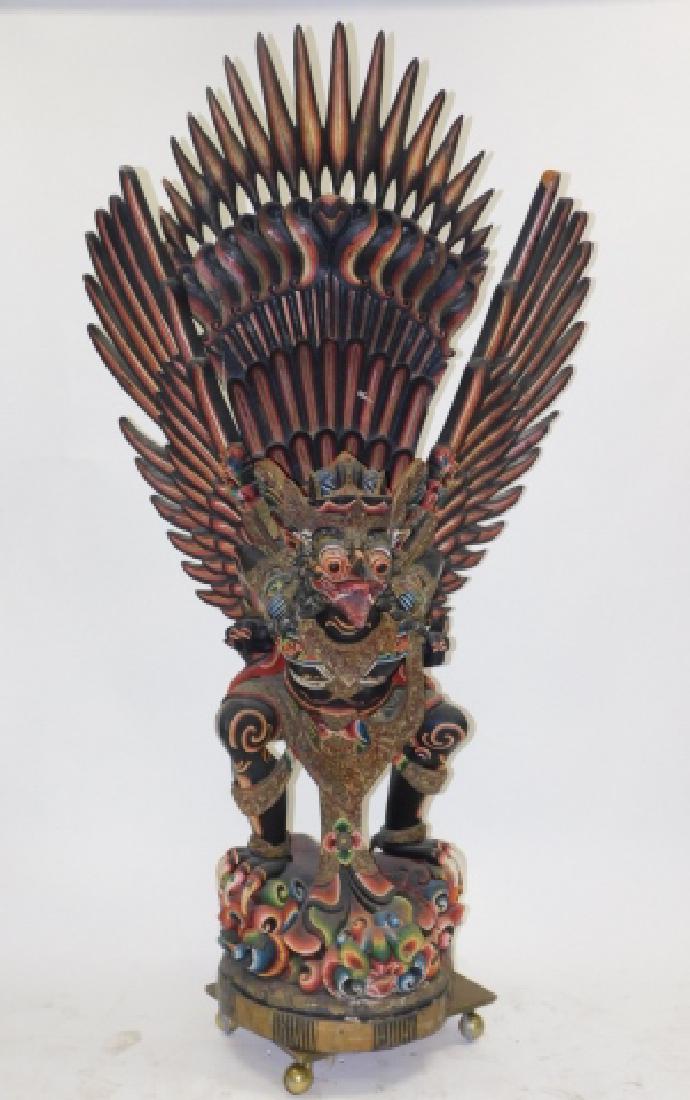 CARVED AND PAINTED WOODEN DRAGON: 7 1/2 FOOT TALL. WINGS AND TOP COMES OFF FOR SHIPPING. MISSING FEATHERS AND PARTS. SPLITTING IN WOOD.