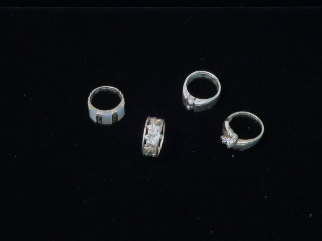 4 Sterling Rings: 1 with mother of pearl and marcasite, 2 all sterling, 1 with stones. Size 6-8