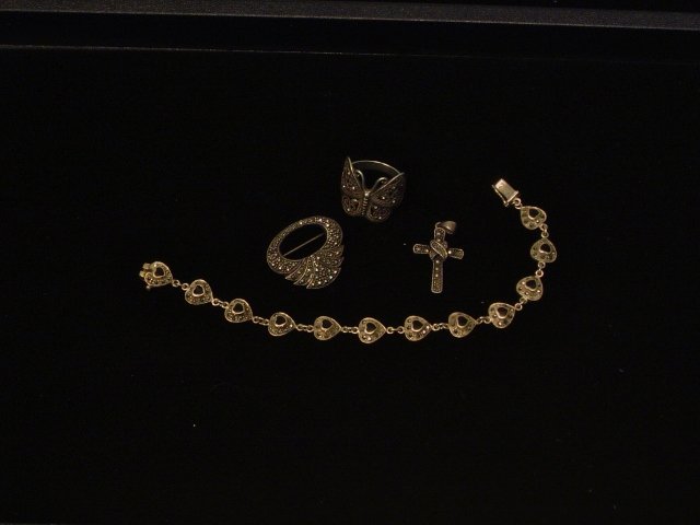 4 Pieces Sterling Jewelry: 1 bracelet with marcasite and onyx, 1 oval pin with marcasite, 1 marcasite cross, 1 butterfly ring